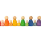 12 wooden people in 6 different rainbow colours.  they are standing in pairs, one larger sized wooden person next to the baby wooden person in the corresponding colour.